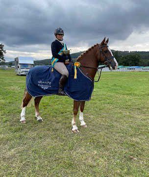 Triumphs and Awards for 16 Year old Ruby Ruby and their Horse Standing after winning a competition.
