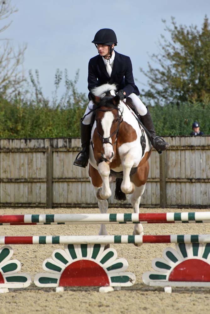 equestrian-jumping-over-jump-on-a-horse